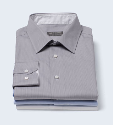 A stack of three INDOCHINO premium custom shirts.